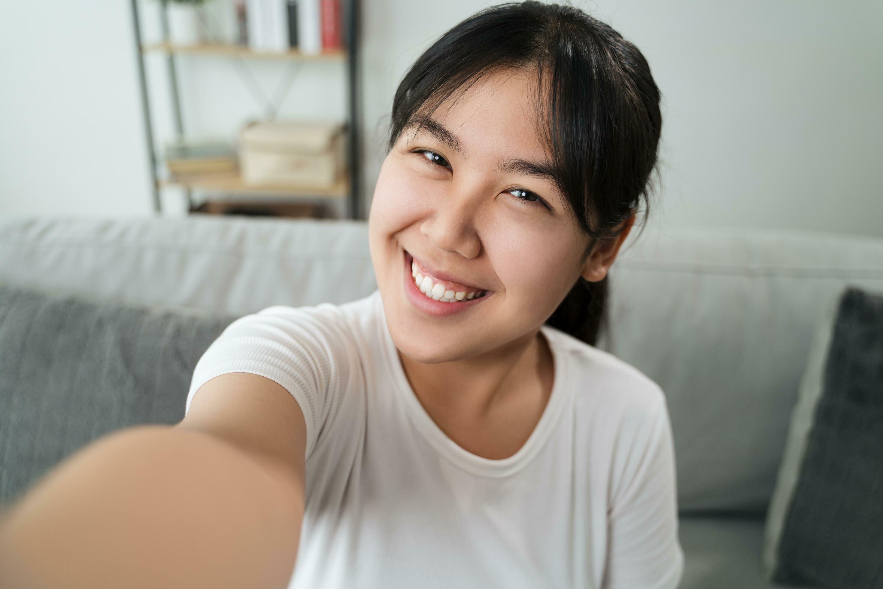 files/young-asian-happy-woman-takes-a-selfie-sitting-on-the-sofa-at-home-free-photo.jpg